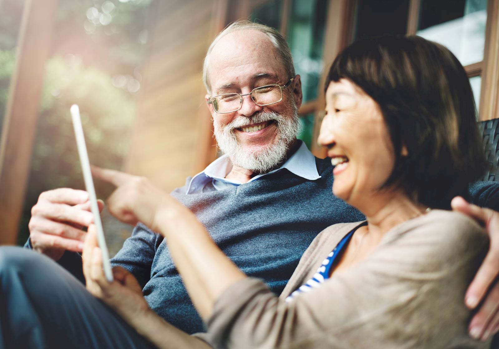 Couple smiling looking at tablet